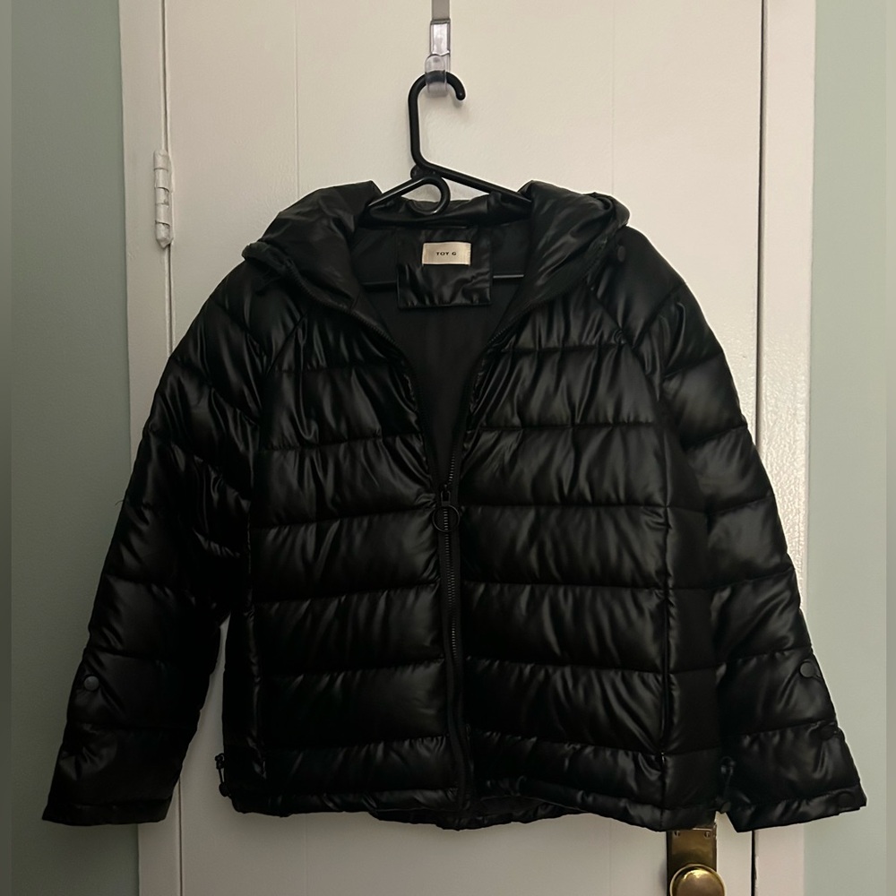 Black Puffer Jacket, with hood and zippered pockets.  Three snaps on sleeves.